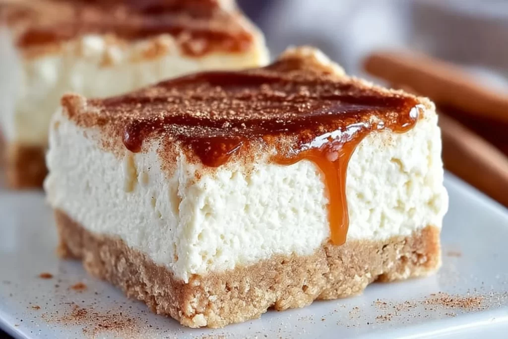 No bake keto churro cheesecake bars topped with cinnamon sugar