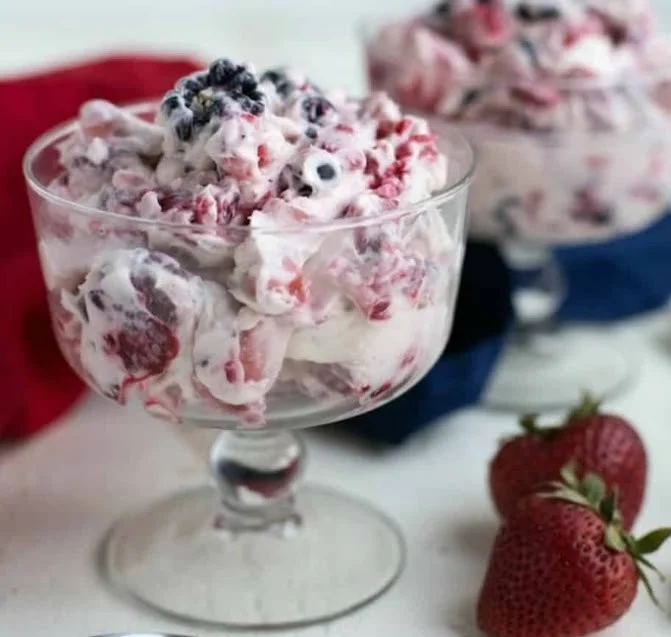 Delicious Berry Cheesecake Salad served in a bowl with fresh berries and cream.