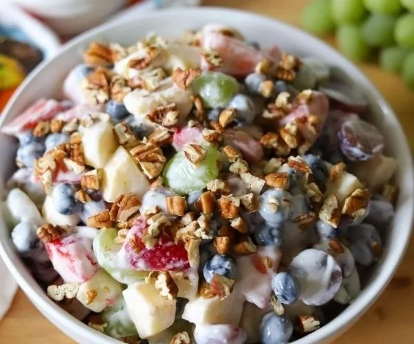 Colorful fruit salad topped with creamy honey yogurt dressing.