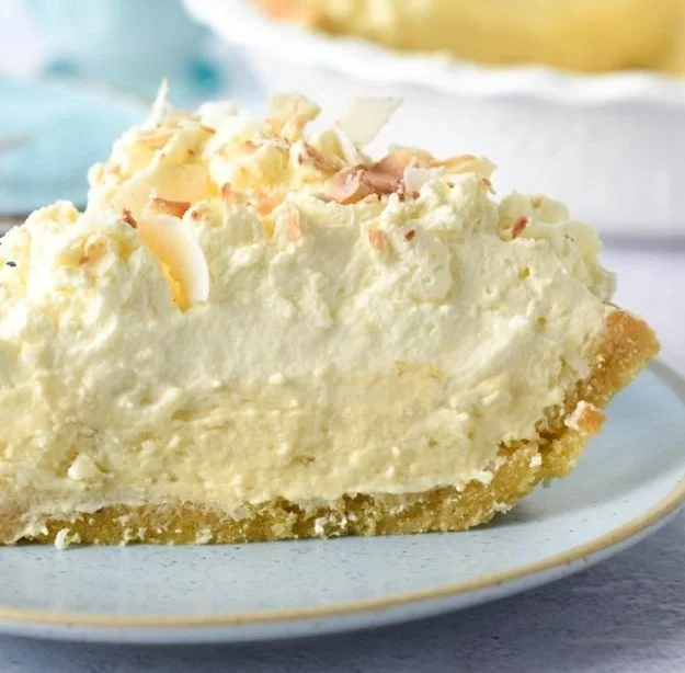 Slice of irresistible Keto Coconut Pie with toasted coconut topping.