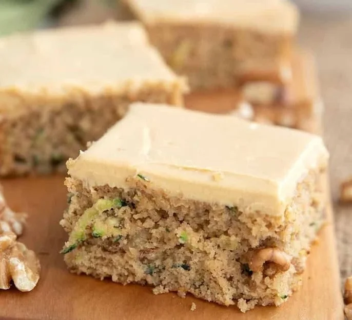 Keto Zucchini Bars with creamy caramel frosting on a plate