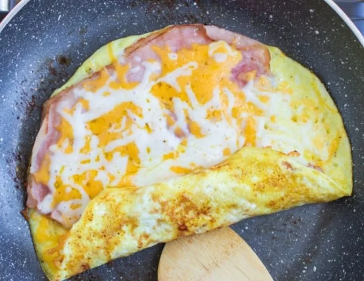 Low carb breakfast roll ups served on a plate with fresh vegetables