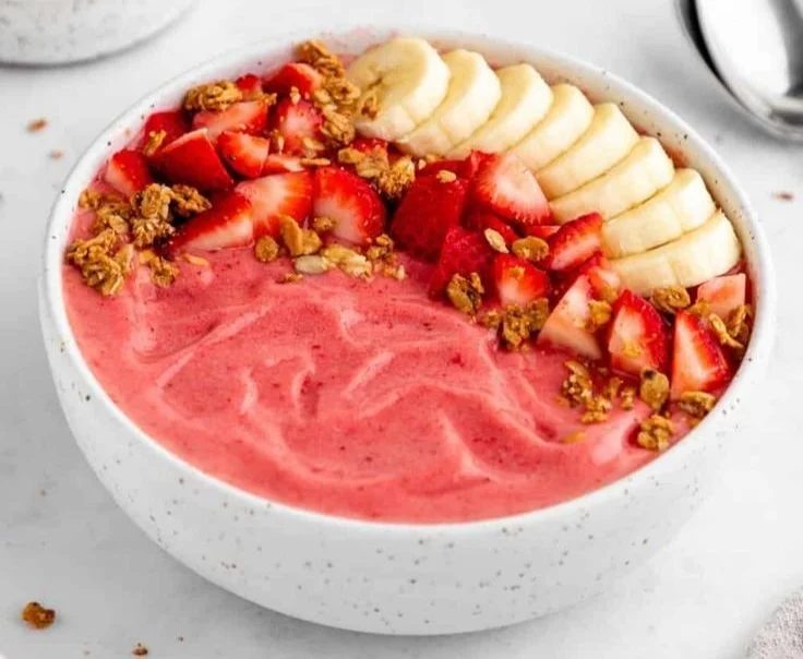 Delicious Strawberry Banana Smoothie Bowl topped with fresh fruits and granola.