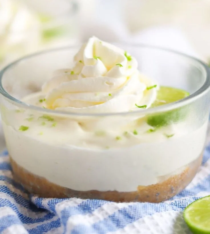Zesty no-bake key lime jars topped with whipped cream and lime slices